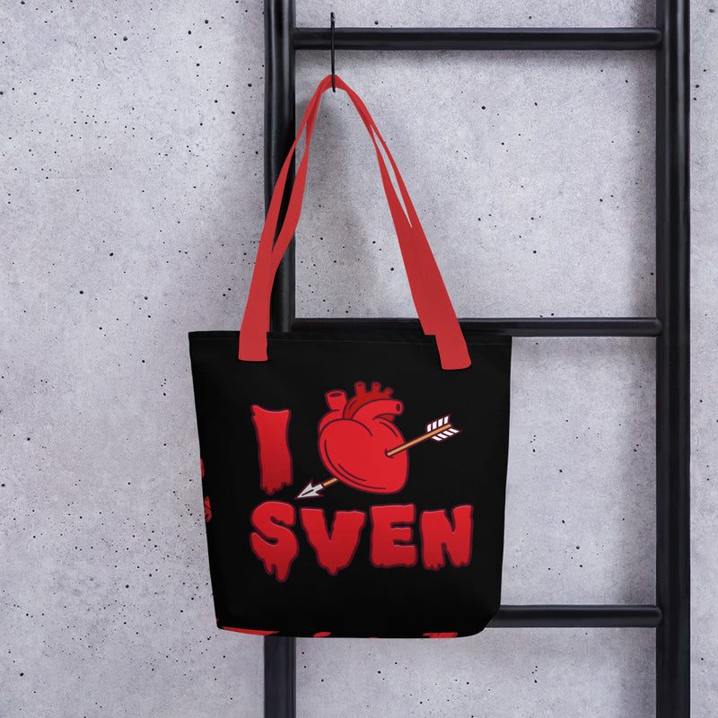 Black tote bag with red handles featuring a red heart pierced by an arrow with the text 'I' and 'SVEN' in red dripping letters below, forming 'I Heart Sven'.