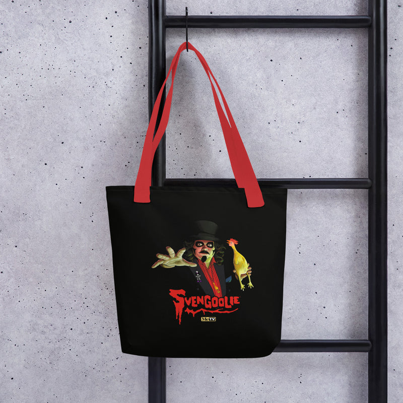Black tote bag with red handles featuring Svengoolie in a top hat reaching forward with a yellow chicken, with the text 'Svengoolie' in red below and a MeTV logo.