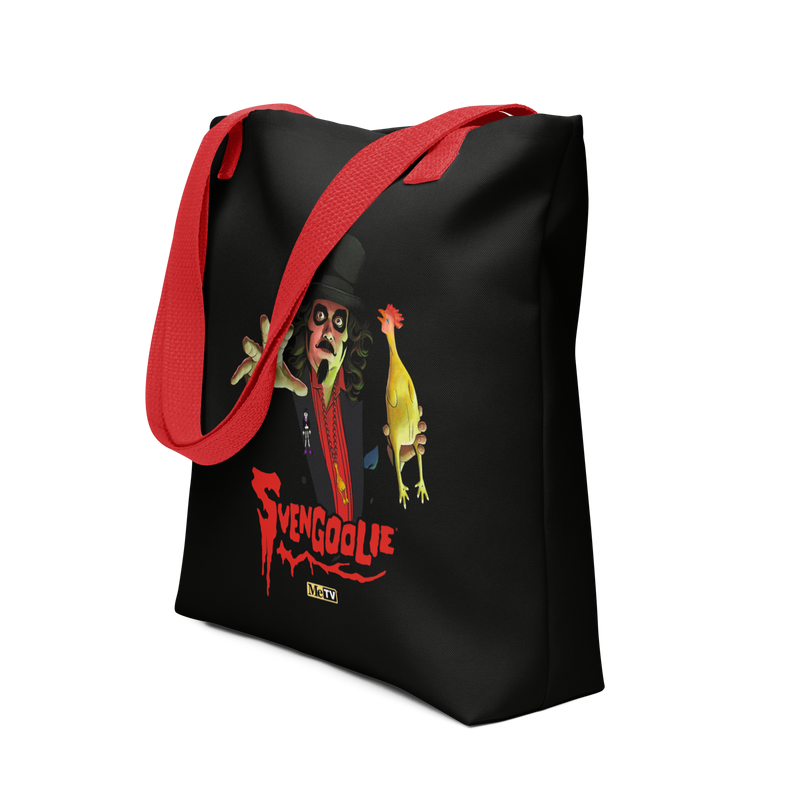 Angled view of black tote bag with red handles featuring Svengoolie in a top hat reaching forward with a yellow chicken, with the text 'Svengoolie' in red below and a MeTV logo.