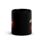 Side view of black glossy ceramic mug featuring Svengoolie's hand and red dripping Svengoolie lettering, with bats and a partially visible MeTV logo on a red glow at left.