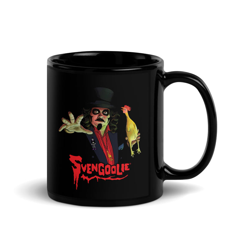 Black glossy ceramic mug with a Svengoolie character illustration featuring Svengoolie reaching forward and holding a yellow chicken, with the text 'Svengoolie' in red below him.