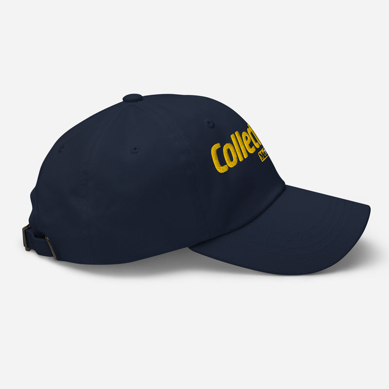 Side view of navy dad hat with a yellow embroidered 'Collector's Call' logo on the side panel and a metal buckle strap at the back.