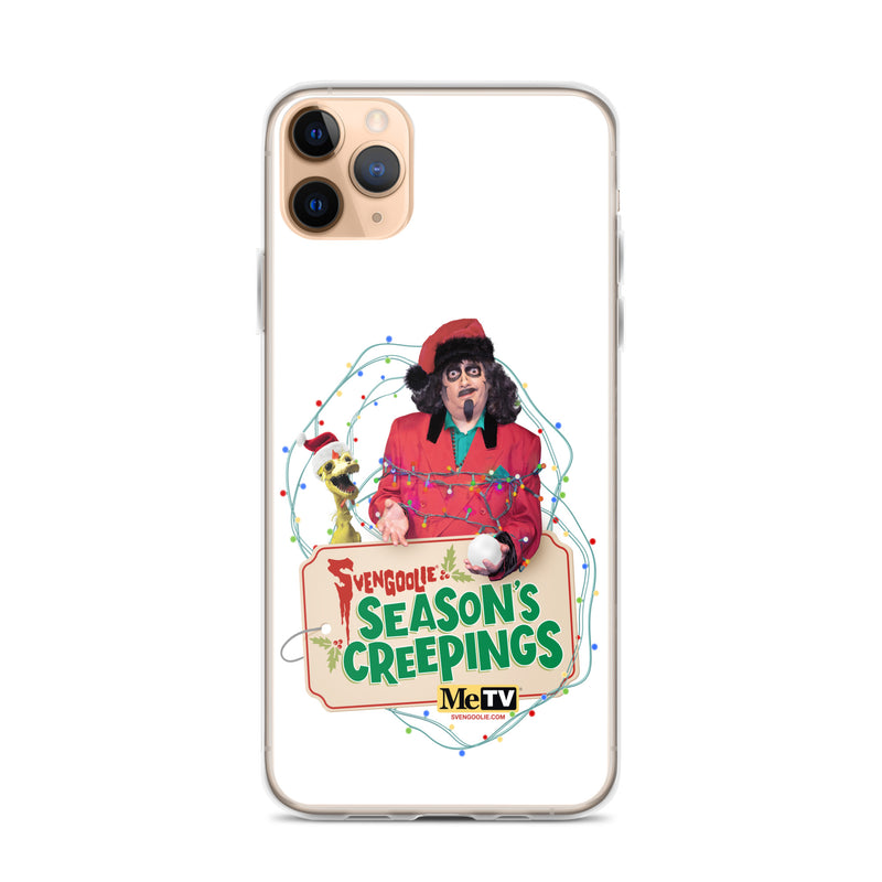 Front of a gold iPhone 11 Pro in the clear Sventa Claus case, showing the Svengoolie and Kerwyn artwork with string lights and the 'Season's Creepings' sign.