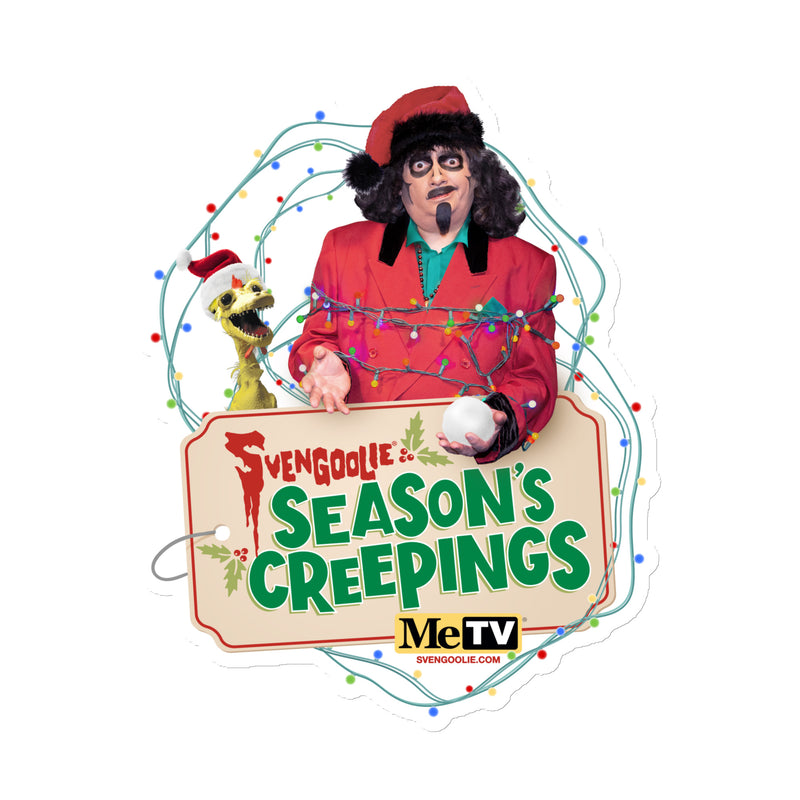 Red die-cut magnet featuring Svengoolie in a red suit wrapped in string lights beside Kerwyn in a Santa hat, with the text 'Season's Creepings' in green below them.