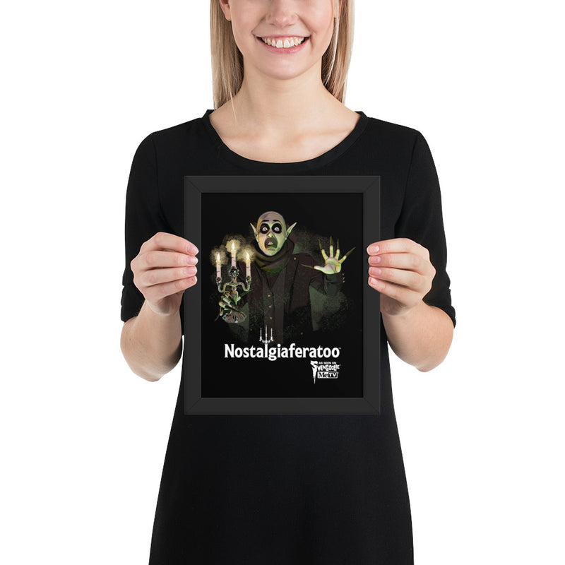 Model holding the framed Nostalgiaferatoo art print showing the vampire artwork and the white text 'Nostalgiaferatoo' on the black background.