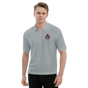 Model wearing Gray polo shirt with small embroidered Svengoolie logo on left chest: "MeTV" logo below.