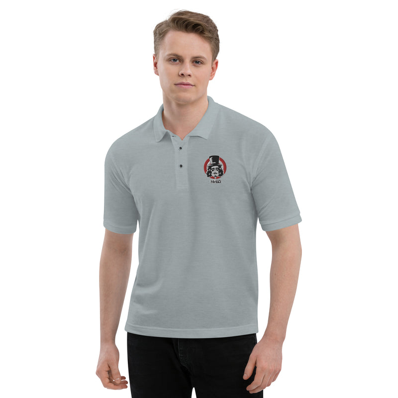Model wearing Gray polo shirt with small embroidered Svengoolie logo on left chest: "MeTV" logo below.