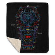 Black throw blanket with blue, red, and purple line art of a coffin, top-hat skeleton, and 'Svengoolie' logo. folded corner showing sherpa lining