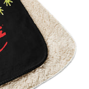 Close-up of corner of black sherpa throw blanket featuring the Svengoolie graphic with the text 'Svengoolie' in red lettering, with cream sherpa border.