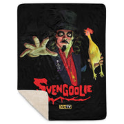 Black sherpa-lined throw blanket with a Svengoolie character illustration featuring Svengoolie reaching forward and holding a yellow chicken, with the text 'Svengoolie' in red below him.