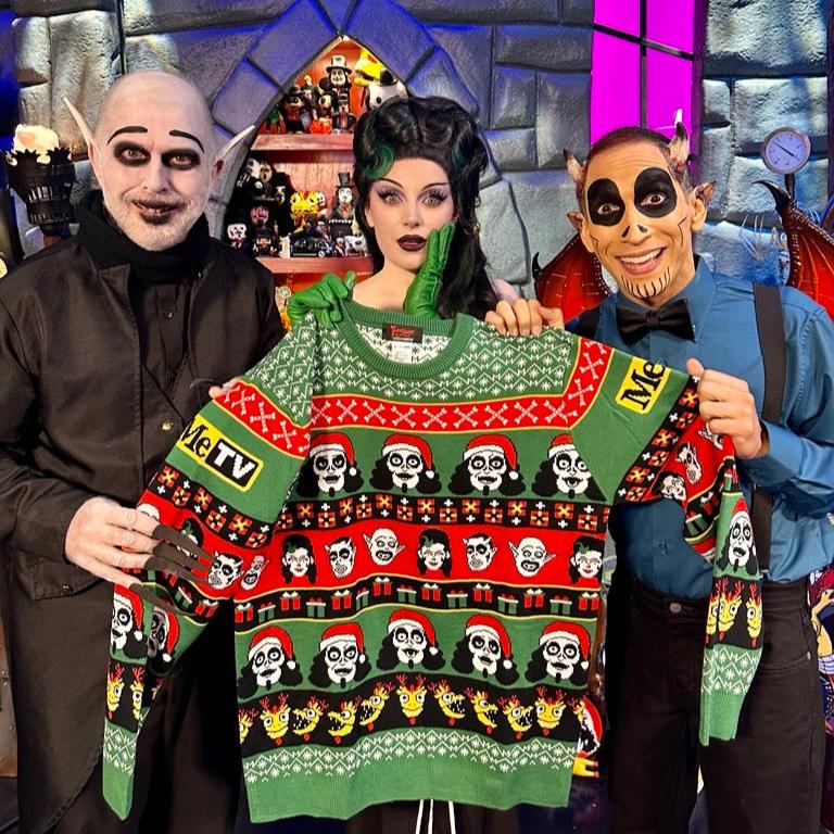 The Sven Squad is holding the holiday knit sweater in front of a dungeon back drop.
