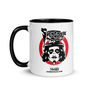 White ceramic mug with black interior and handle featuring the Svengoolie face logo over a red circle with the text 'Svengoolie' in black above it and 'MeTV' with 'SVENGOOLIE.COM' in black below it.
