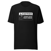Black t-shirt featuring a black caution sign graphic with the text 'CAUTION' and 'ARMED WITH DAD JOKES' beside a flexing arm icon.