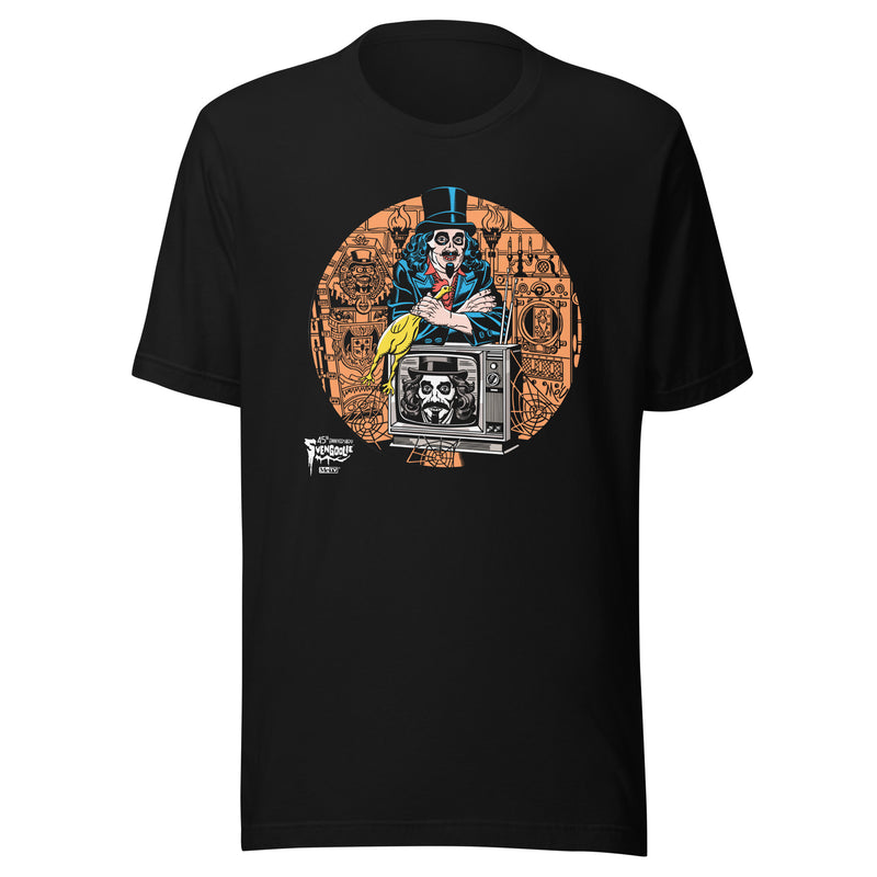 Black t-shirt featuring Svengoolie holding a rubber chicken, by a TV with Orange circle border. Svengoolie logo at lower left.