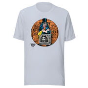 Light Blue t-shirt featuring Svengoolie holding a rubber chicken, by a TV with Orange circle border. Svengoolie logo at lower left.