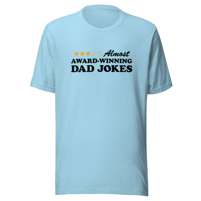 Light blue short-sleeved t-shirt featuring a three-of-five star rating graphic with the text 'Almost AWARD-WINNING DAD JOKES' in black on the chest
