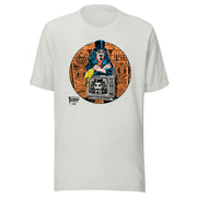 Silver t-shirt featuring Svengoolie holding a rubber chicken, by a TV with Orange circle border. Svengoolie logo at lower left.