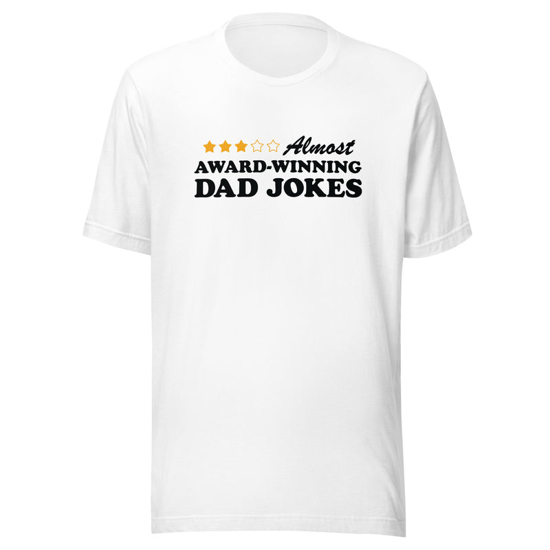White short-sleeved unisex t-shirt featuring a three-of-five star rating graphic with the text 'Almost AWARD-WINNING DAD JOKES' in black on the chest