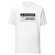 White t-shirt featuring a black caution sign graphic with the text 'CAUTION' and 'ARMED WITH DAD JOKES' beside a flexing arm icon.