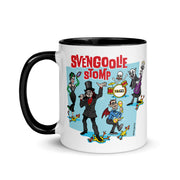 White mug with black handle and interior featuring a cartoon band of Svengoolie characters with red SVENGOOLIE STOMP text and Svengoolie logo to left