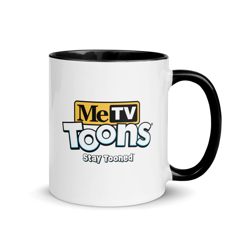White ceramic mug with black handle and blue interior featuring the MeTV Toons logo with the text 'Stay Tooned' in black below it.