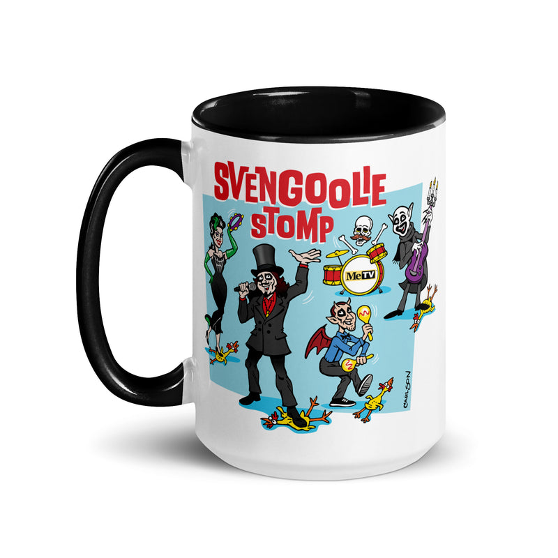 White mug with black handle and interior featuring a cartoon band of Svengoolie characters with red SVENGOOLIE STOMP text and Svengoolie logo to left