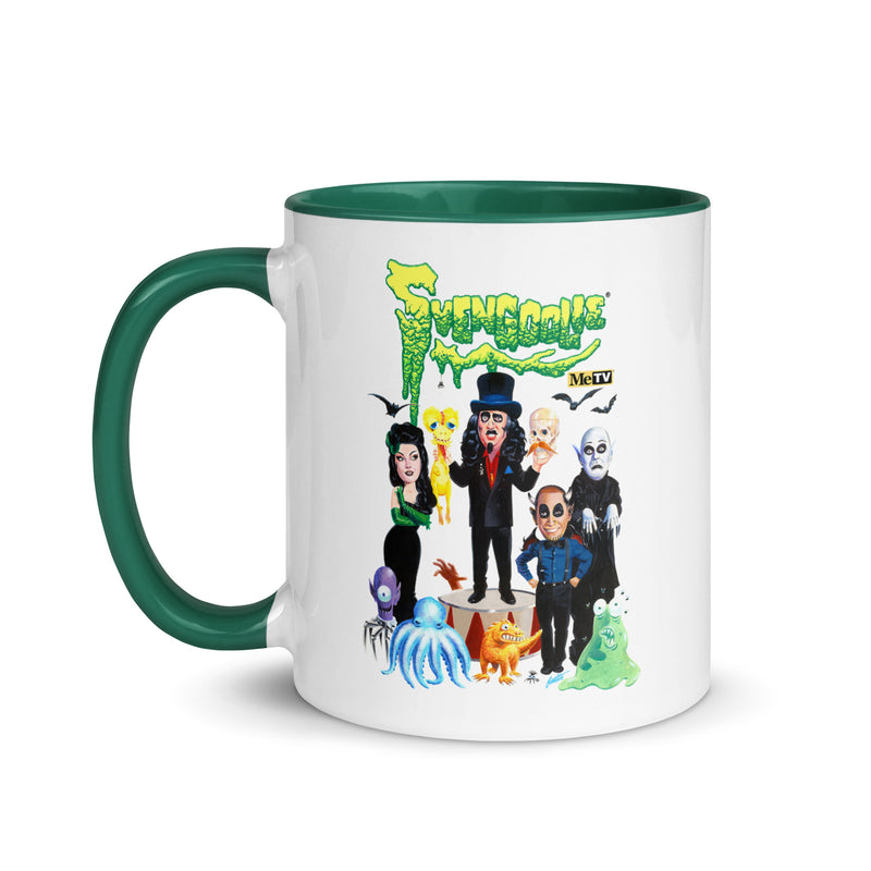 White mug with green handle and inside featuring Svengoolie and the Sven Squad alongside small monster characters with the text 'Svengoolie' in green dripping letters and a MeTV logo at the top.
