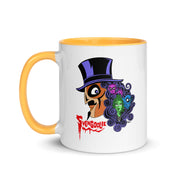 Front view of white mug with yellow handle and interior featuring Svengoolie in a top hat with curly hair, and the faces of the Sven Squad in his hair, with the text 'Svengoolie' in red.