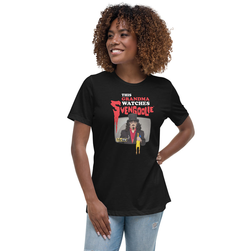 Model wearing black t-shirt featuring Svengoolie holding a rubber chicken with the text 'This Grandma Watches Svengoolie' in black and red above it.