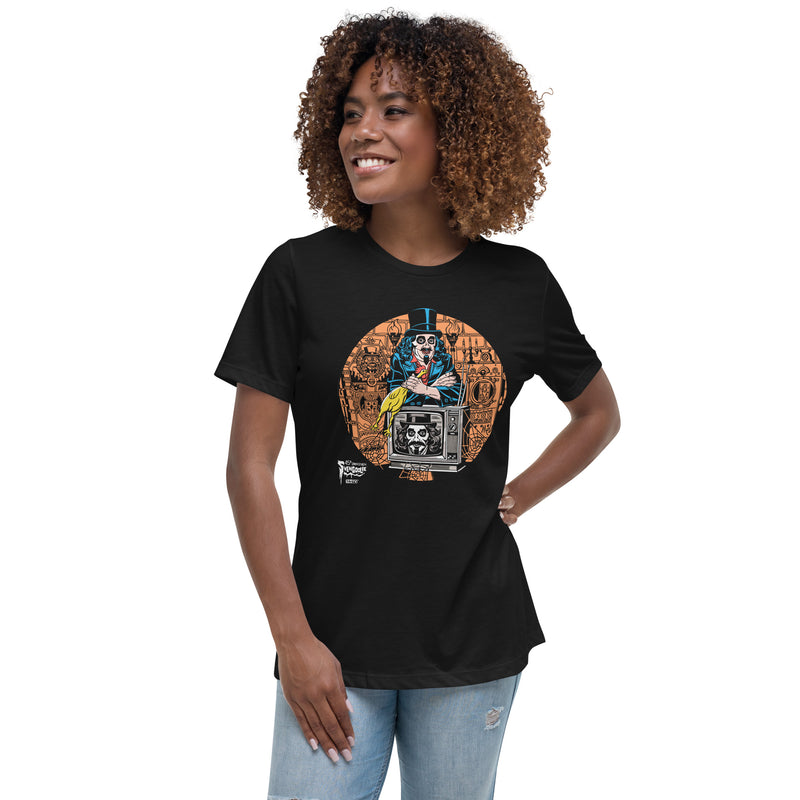 Model wearing black t-shirt featuring Svengoolie holding a rubber chicken, by a TV with Orange circle border. Svengoolie logo at lower left.