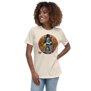 Model wearing Tan t-shirt featuring Svengoolie holding a rubber chicken, by a TV with Orange circle border. Svengoolie logo at lower left.