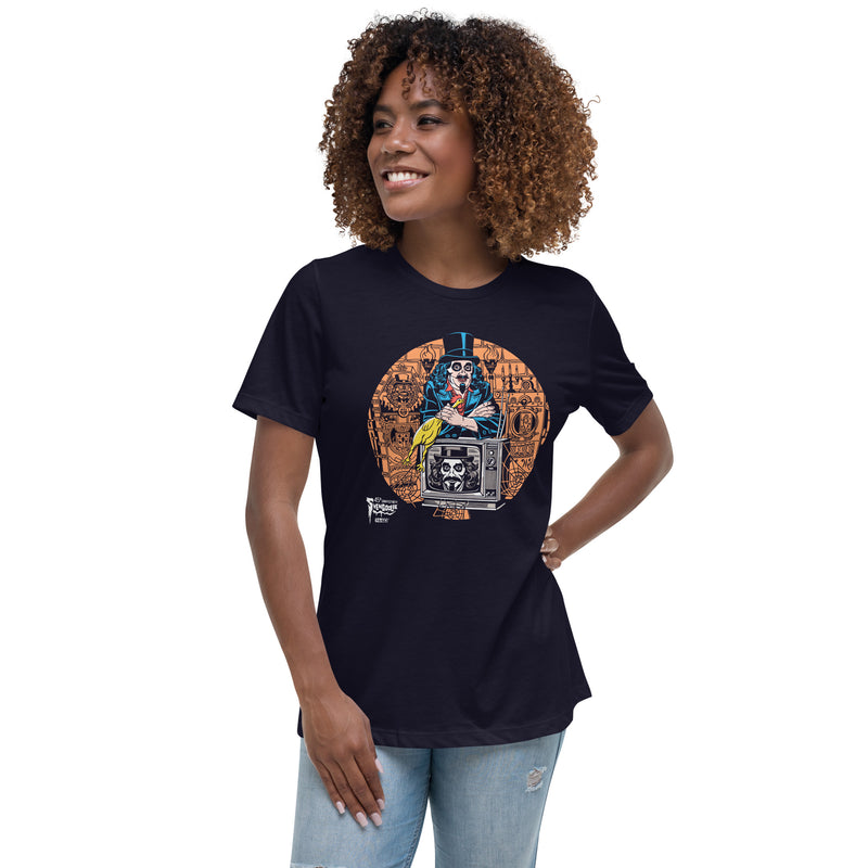Model wearing Navy t-shirt featuring Svengoolie holding a rubber chicken, by a TV with Orange circle border. Svengoolie logo at lower left.