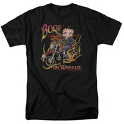 Black t-shirt with cartoon Betty Boop riding a red motorcycle, flame graphics, and printed text 'BOOP' above and 'ON WHEELS!' below.