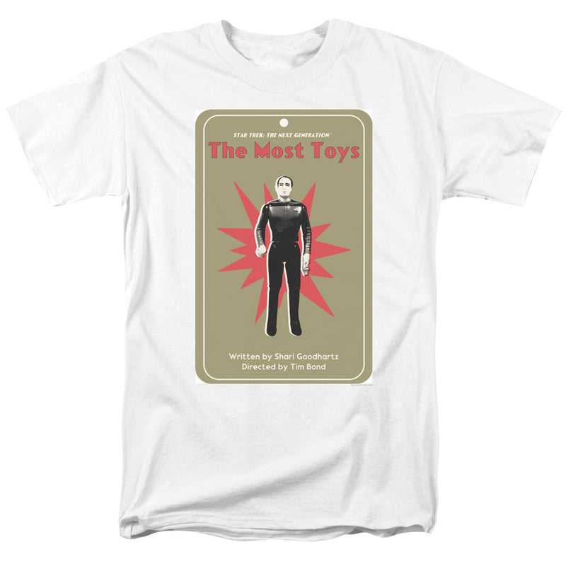 White short-sleeved t-shirt featuring a tan trading-card graphic of a figure in a black uniform with the text 'The Most Toys' in red at the top