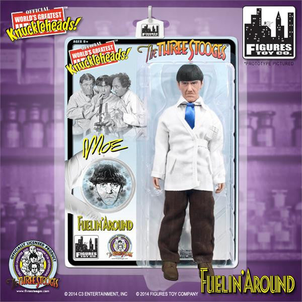 Moe Howard action figure in white lab coat, blue tie, and brown pants, in Figures Toy Co. packaging for The Three Stooges Knuckleheads series.
