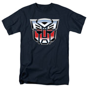 Navy short-sleeve t-shirt with a large chrome-style red, silver, and black Autobot logo emblem across the chest from the Transformers franchise.