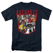 Navy blue crew neck t-shirt with red 'AUTOBOTS' text over a red shield-shaped graphic filled with colorful Transformers robot characters in a collage.