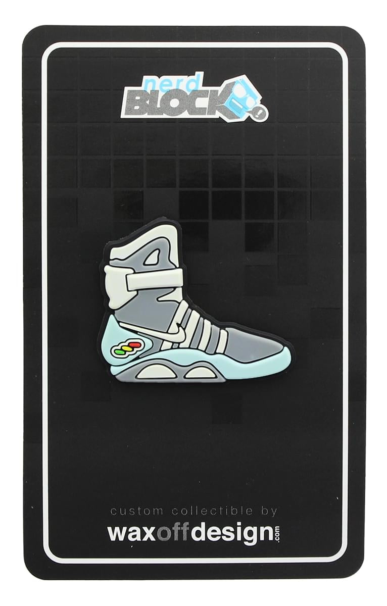 Gray and light blue enamel collector pin shaped like Marty McFly's Back to the Future hightop sneaker, on a black display card.