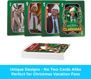 Fanned jack, queen, king, and ace of clubs from the Christmas Vacation playing cards, with the ace reading 'MERRY CLARKMAS' in glowing green letters.