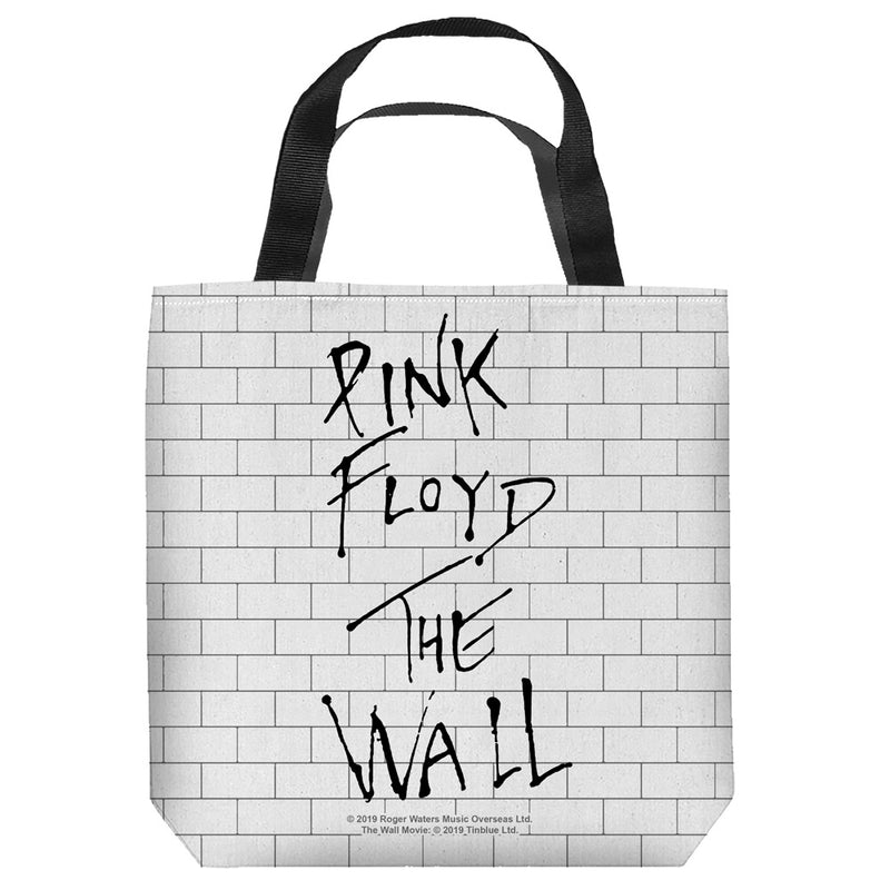 White tote bag with black handles and a white brick wall print, featuring black handwritten-style text 'PINK FLOYD THE WALL' stacked in three lines.