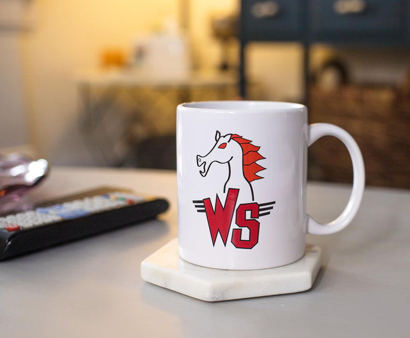 White ceramic mug with a red and black horse head above red 'WS' letters flanked by winged stripes, the Wyld Stallyns logo.