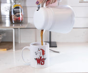White ceramic mug with a red horse head and red 'WS' logo, being filled with coffee from a white carafe.