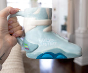 Light blue ceramic mug sculpted like a Back to the Future Nike sneaker, with white 'BACK TO THE FUTURE' printed on the side and blue sole accents.