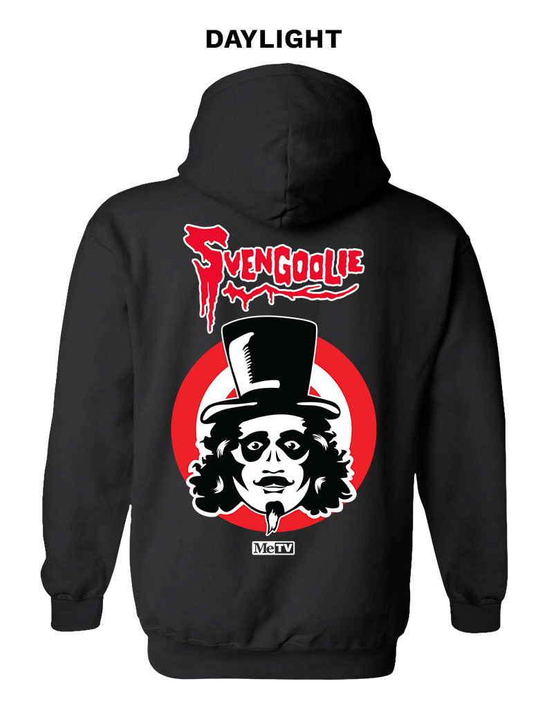 Animated back view of black glow-in-the-dark hoodie featuring red Svengoolie script logo above face illustration on red and white target rings and a white MeTV logo below