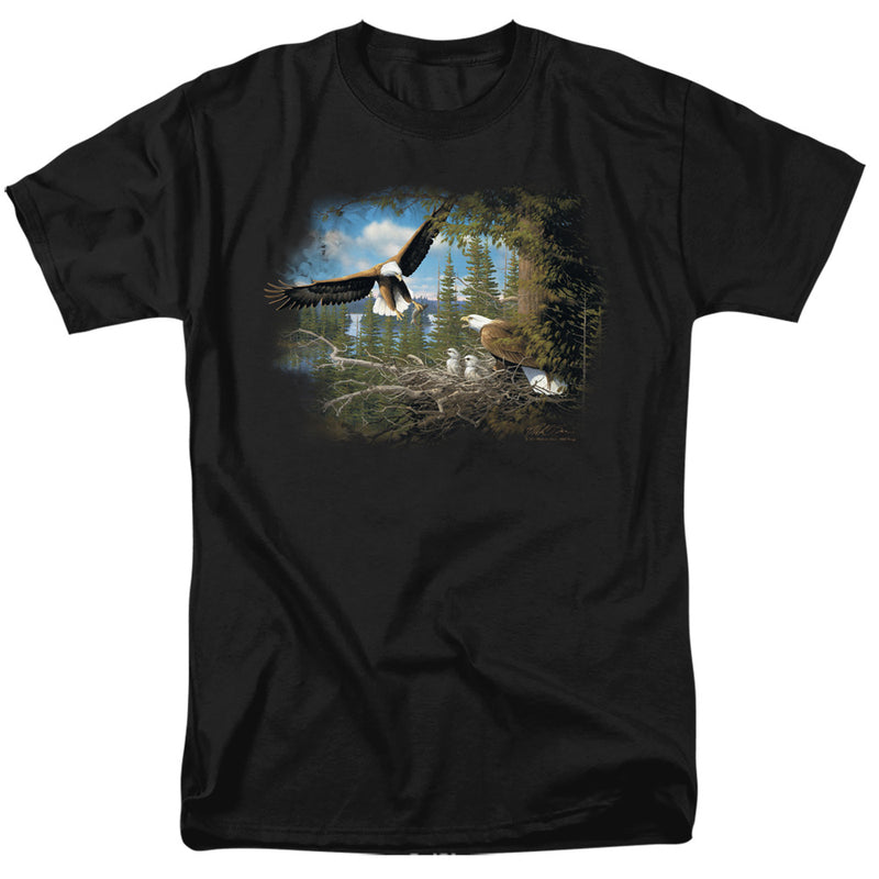 Black t-shirt with a painted scene of bald eagles: one flying over a forest lake, and an adult eagle with two chicks in a nest beside a pine tree.