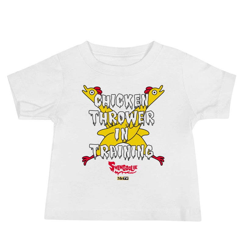 White baby t-shirt with yellow cartoon chickens crossed over the text "CHICKEN THROWER IN TRAINING" and a red "Svengoolie" logo.