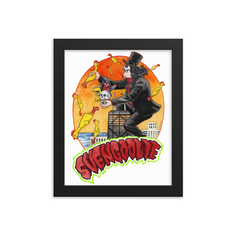 Framed art print of Svengoolie in top hat and black suit, at the top of a skyscraper, holding a skull, surrounded by rubber chickens, with 'SVENGOOLIE' in red letters over an orange sunset city.