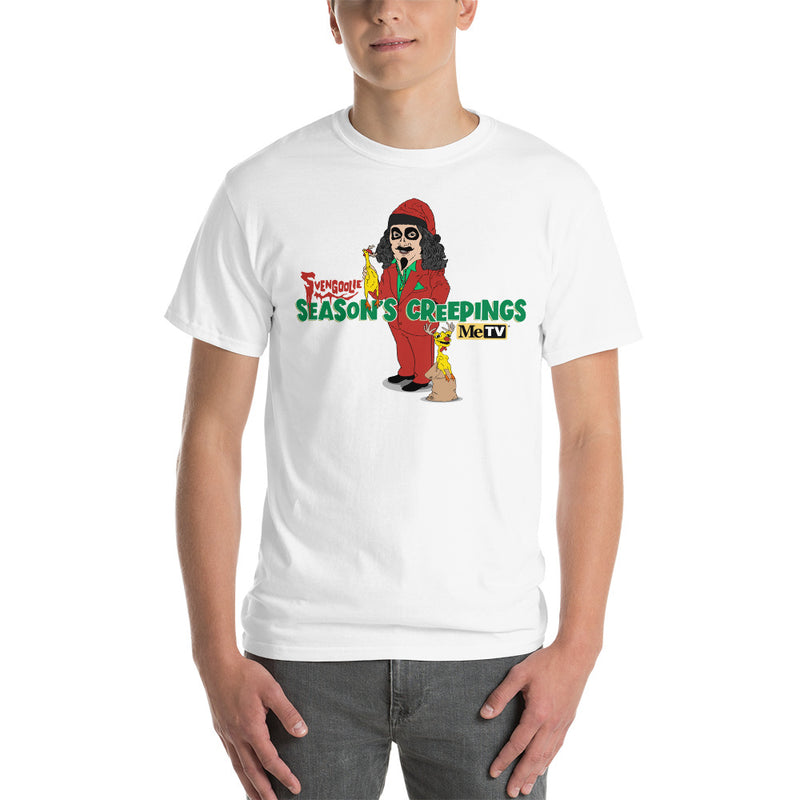 Man wearing white t-shirt with cartoon Svengoolie in red suit holding a chicken, 'Season's Creepings' text and MeTV logo