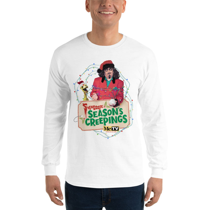 Man wearing white long-sleeve shirt with Svengoolie in red suit holding a chicken, string lights, and "Season's Creepings" text plus MeTV logo.