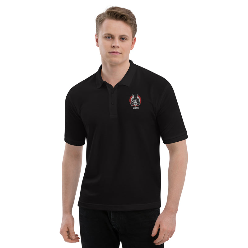 Model wearing Black polo shirt with small embroidered Svengoolie logo on left chest: "MeTV" logo below.